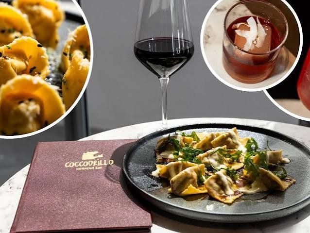 Ravioli plated with a glass of red wine and a negroni
